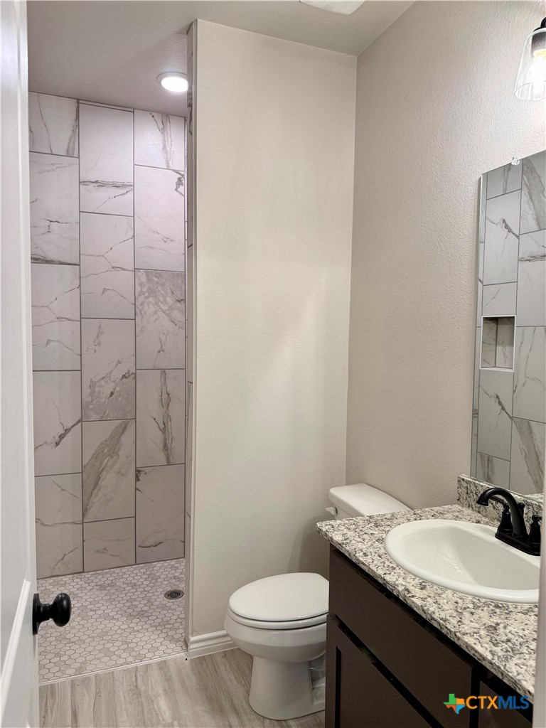 110 Leon Lane Copperas Cove, TX 76522 - Photo 14 of 20 a bathroom with a granite countertop sink toilet and shower