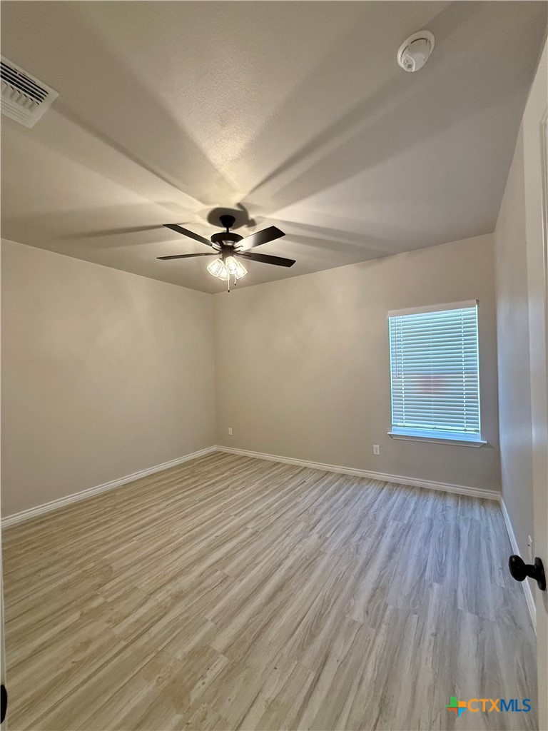 110 Leon Lane Copperas Cove, TX 76522 - Photo 15 of 20 wooden floor in an empty room with a window