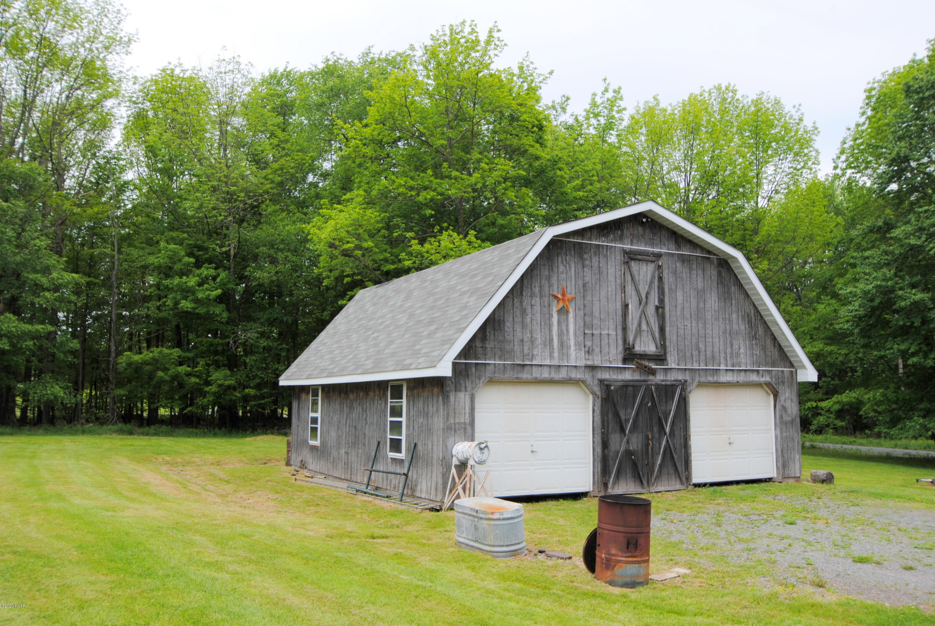 313 Old Racht Road Waymart, PA 18472 - Photo 2 of 39 a front view of a house with yard