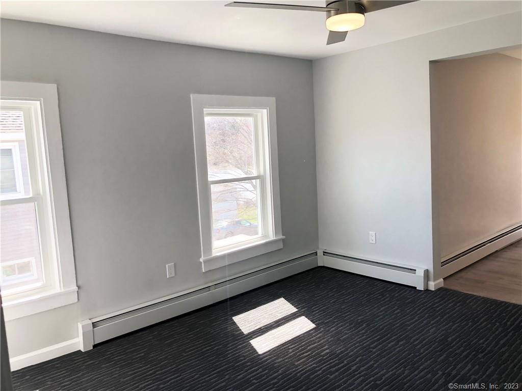359 South Main Street, Unit 2 Middletown, CT 06457 - Photo 20 of 21 an empty room with wooden floor and windows