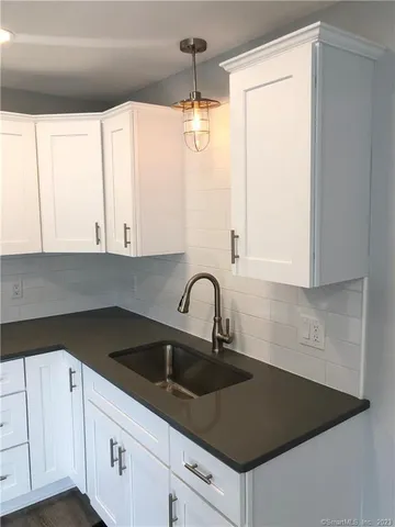 a kitchen with a sink and cabinets
