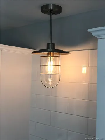 a bathroom with a shower and a plant in it