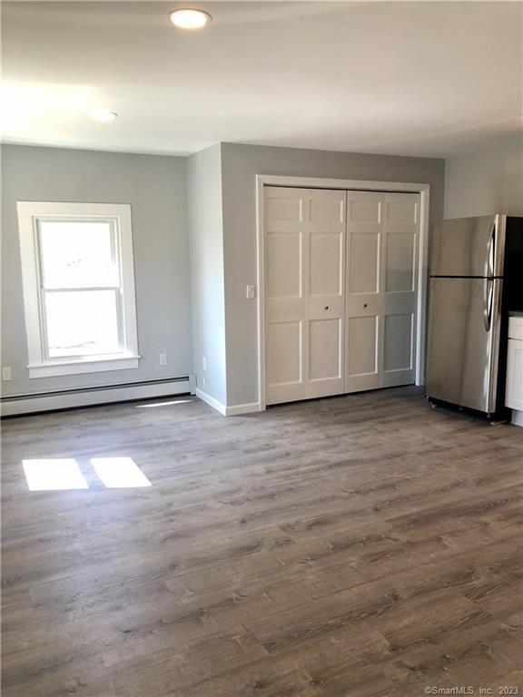 359 South Main Street, Unit 2 Middletown, CT 06457 - Photo 8 of 21 an empty room with wooden floor and windows