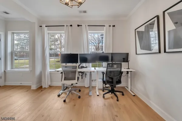 a workspace with wooden floor and a window
