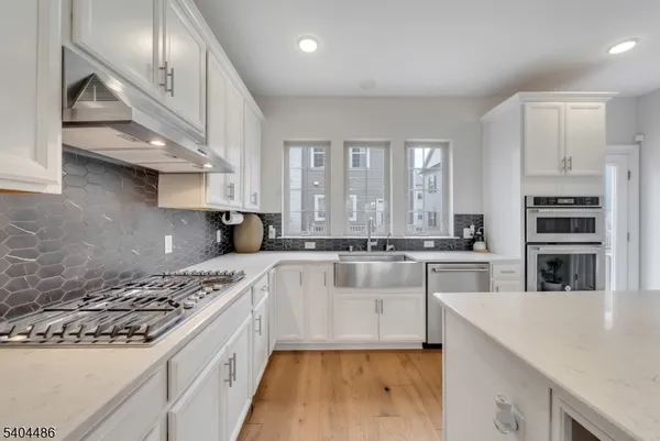 a kitchen with stainless steel appliances granite countertop a stove and a sink