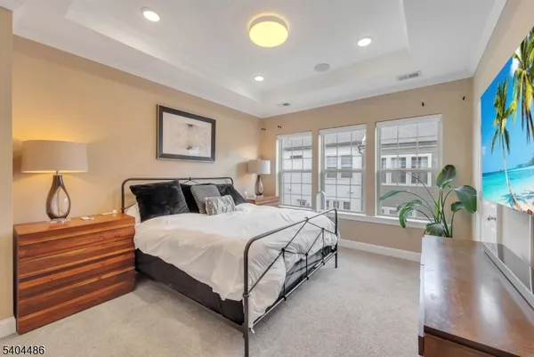 a spacious bedroom with a bed and a large window