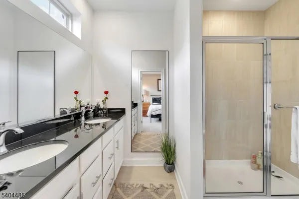 a bathroom with a double vanity sink and mirror