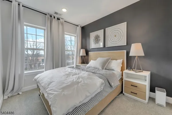 a bedroom with a bed and a night stand