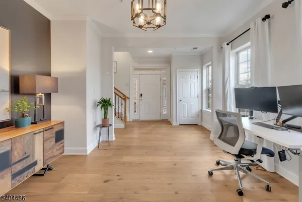 a view of a hallway with workspace and a window