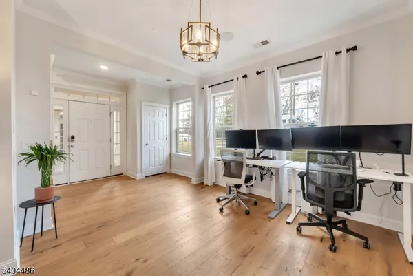 a view of a workspace with furniture and a window