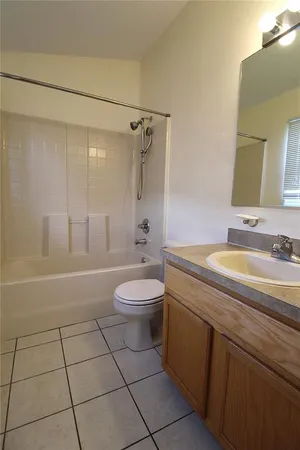 a spacious bathroom with a granite countertop sink a toilet and a shower