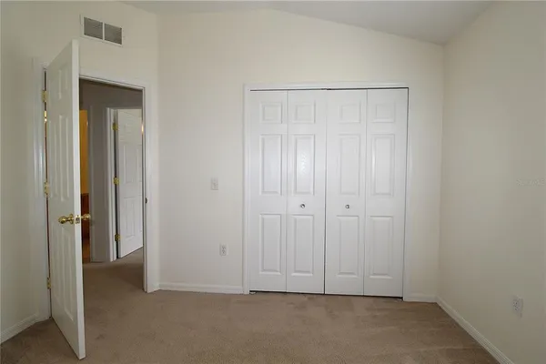 an empty room with closet area