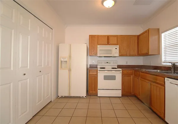 a kitchen with a stove a sink and a refrigerator