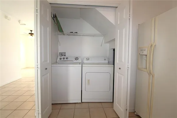 a utility room with cabinets washer and dryer