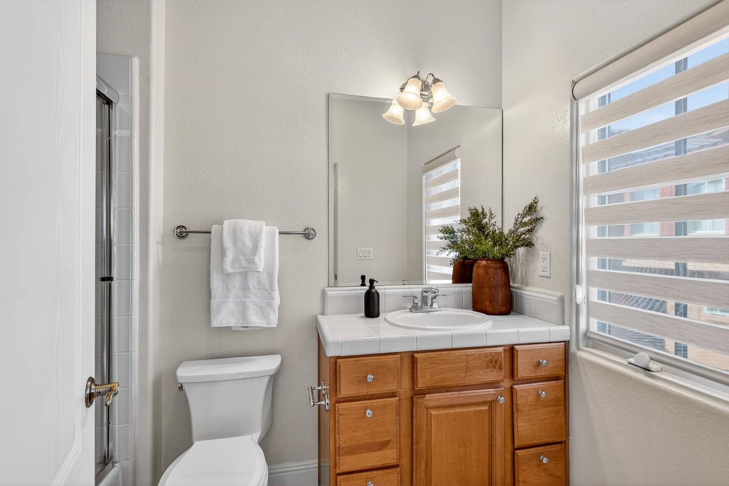 484 Gabilan Street Los Altos, CA 94022 - Photo 22 of 34 a bathroom with a toilet a sink and mirror