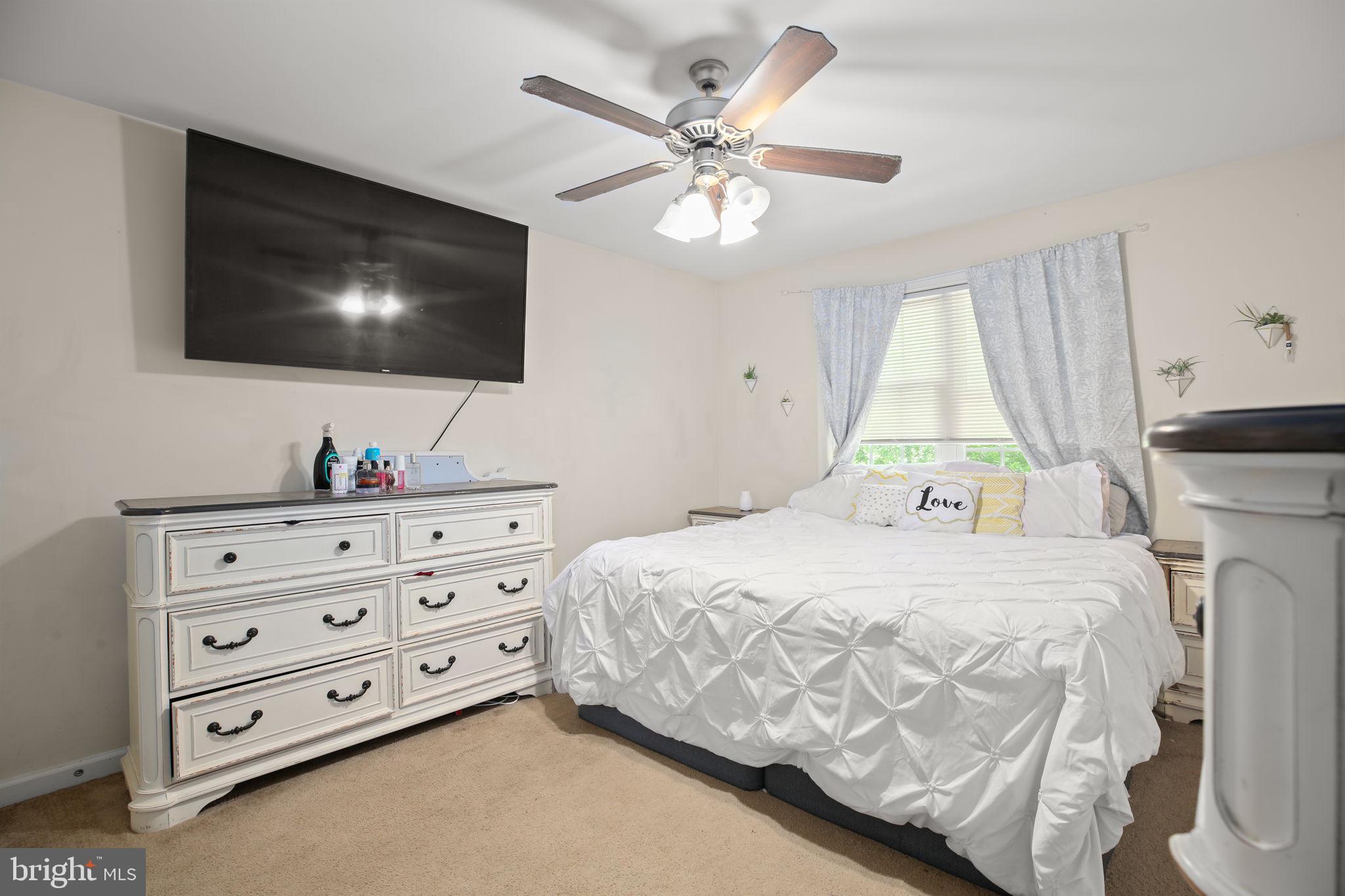317 12th Street Colonial Beach, VA 22443 - Photo 13 of 28 a bedroom with a bed and a flat screen tv