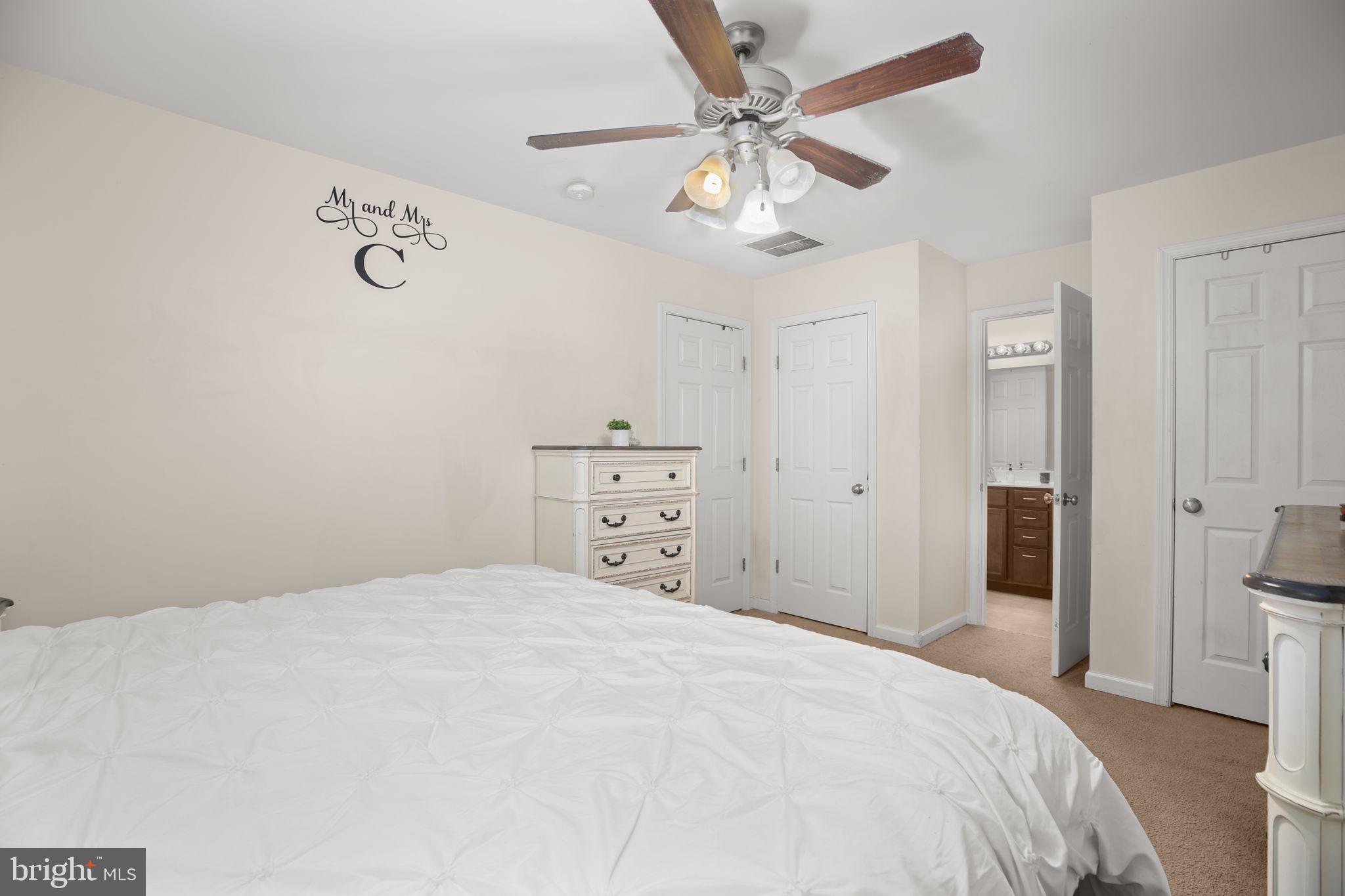 317 12th Street Colonial Beach, VA 22443 - Photo 15 of 28 a bedroom with a large bed and a chandelier