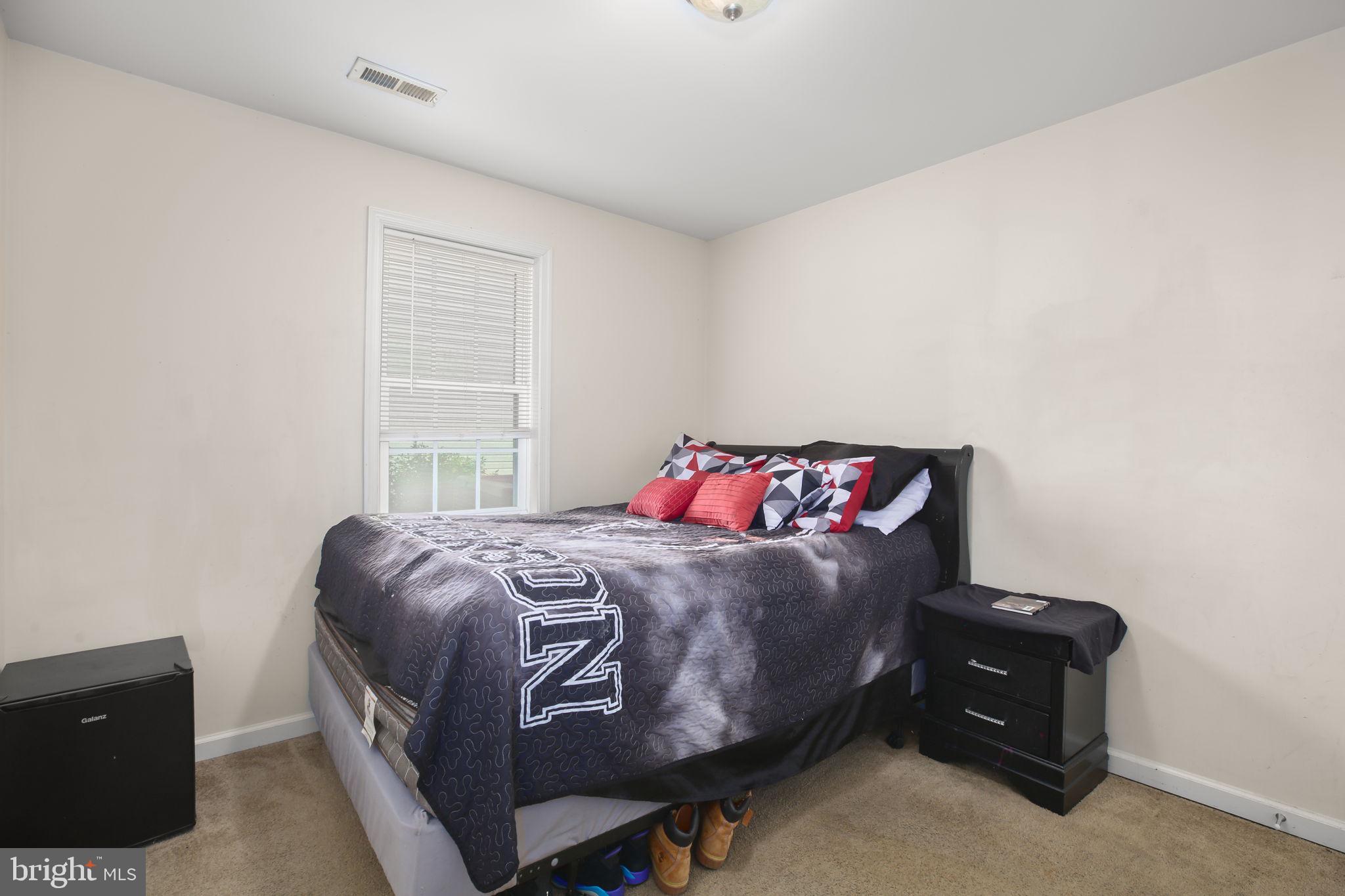 317 12th Street Colonial Beach, VA 22443 - Photo 24 of 28 a bedroom with a bed and a window