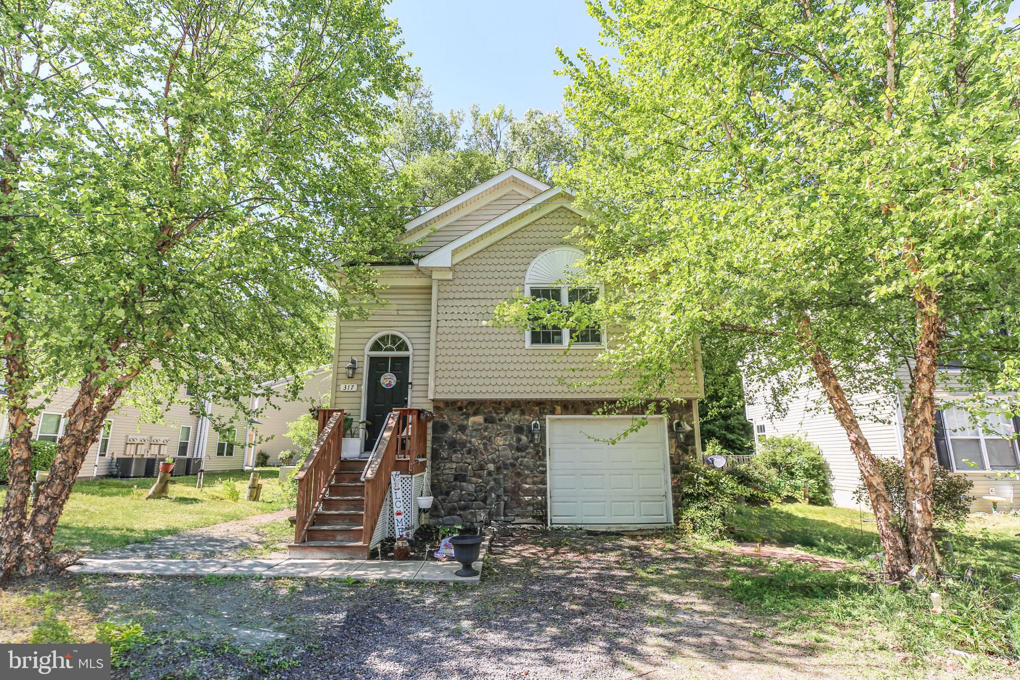 317 12th Street Colonial Beach, VA 22443 - Photo 27 of 28 a view of a house with a yard and large tree
