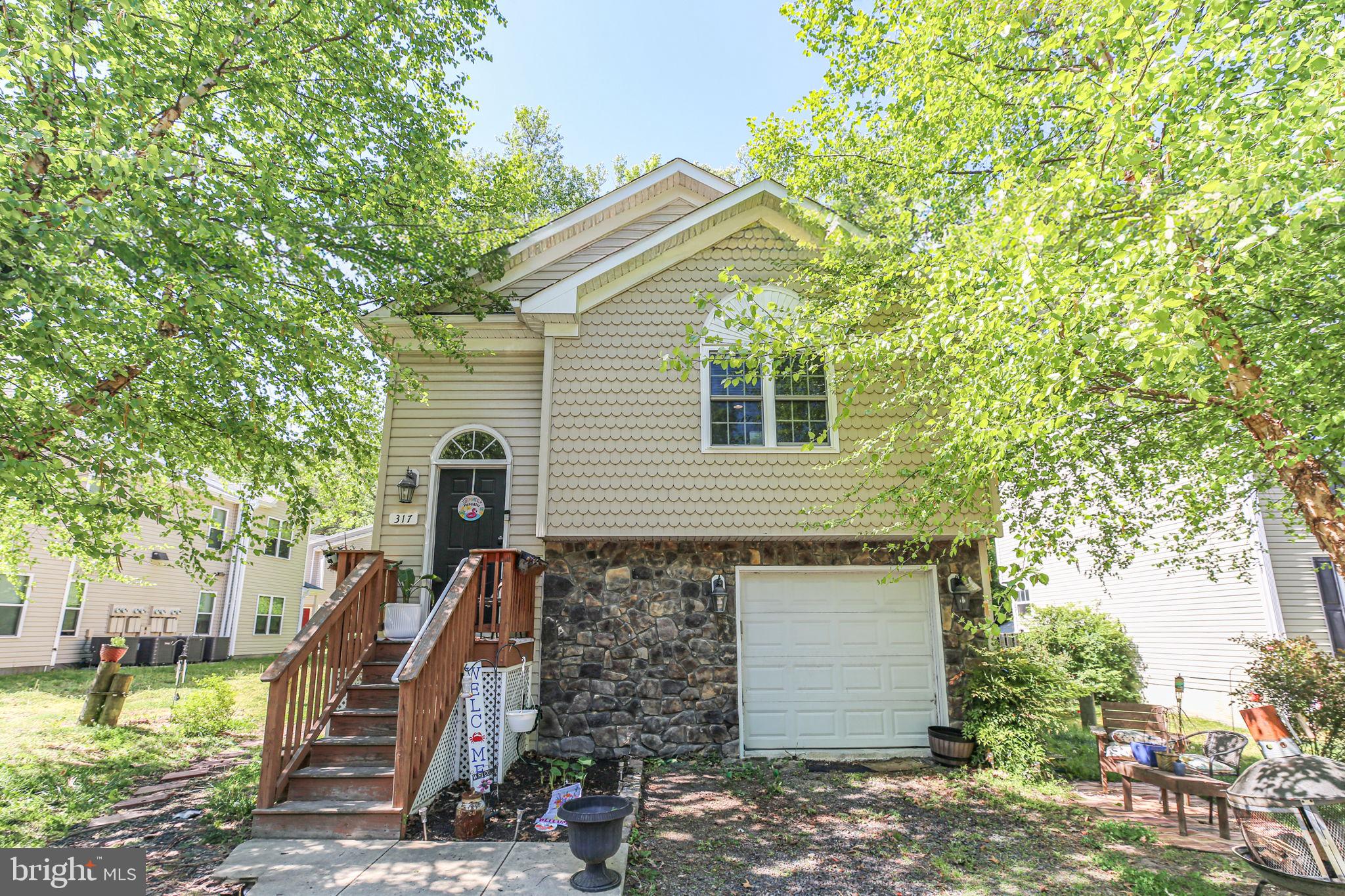 317 12th Street Colonial Beach, VA 22443 - Photo 3 of 28 a front view of house with a garden