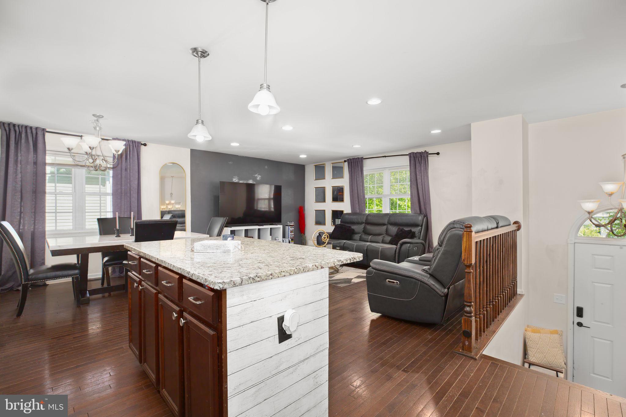 317 12th Street Colonial Beach, VA 22443 - Photo 4 of 28 a kitchen with stainless steel appliances granite countertop sink stove top oven and couches