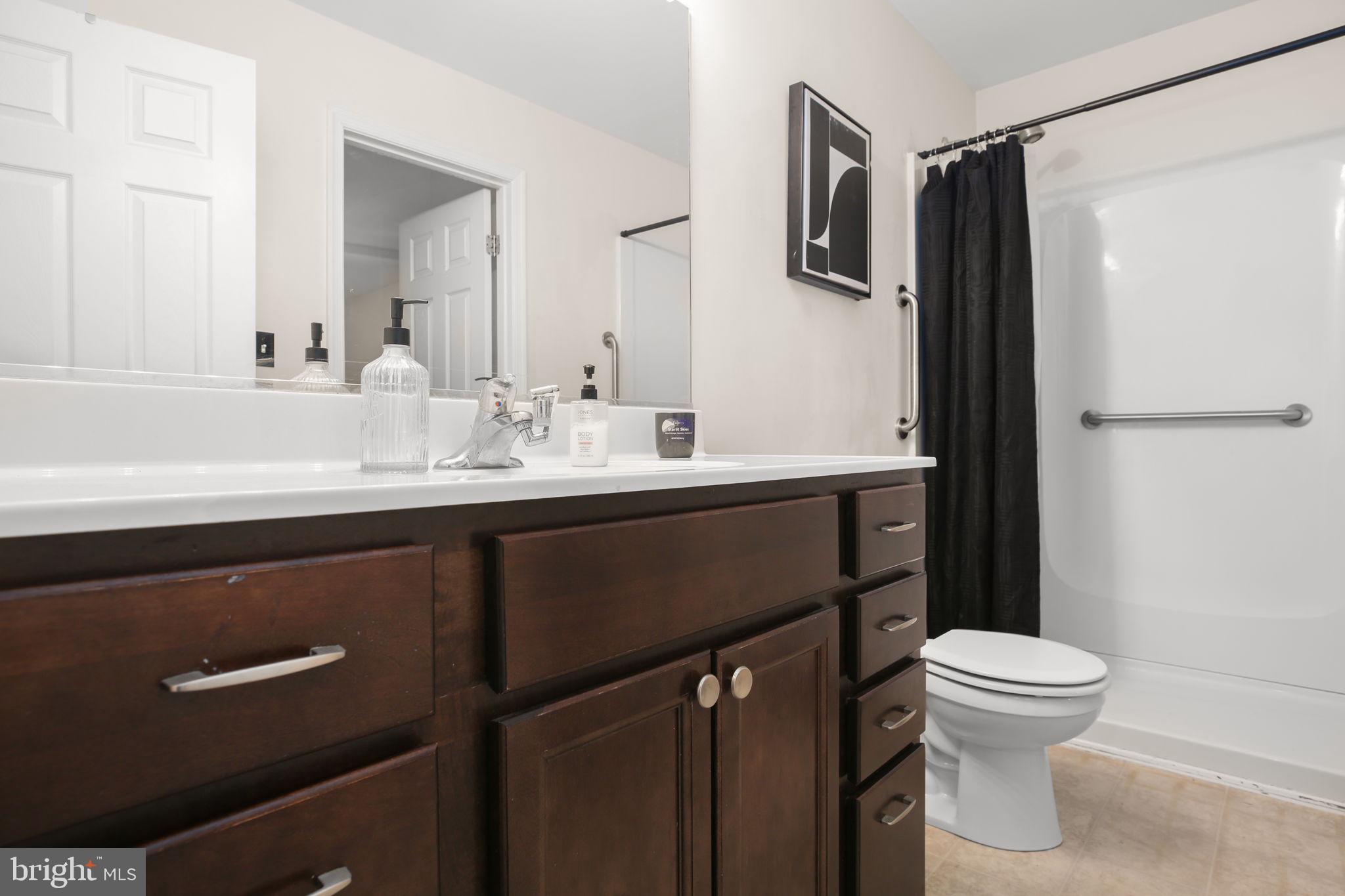 317 12th Street Colonial Beach, VA 22443 - Photo 9 of 28 a bathroom with a sink a toilet and shower