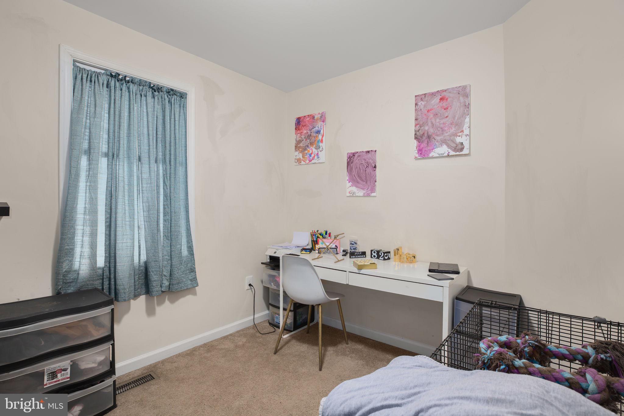 317 12th Street Colonial Beach, VA 22443 - Photo 10 of 28 a bedroom with furniture and a window