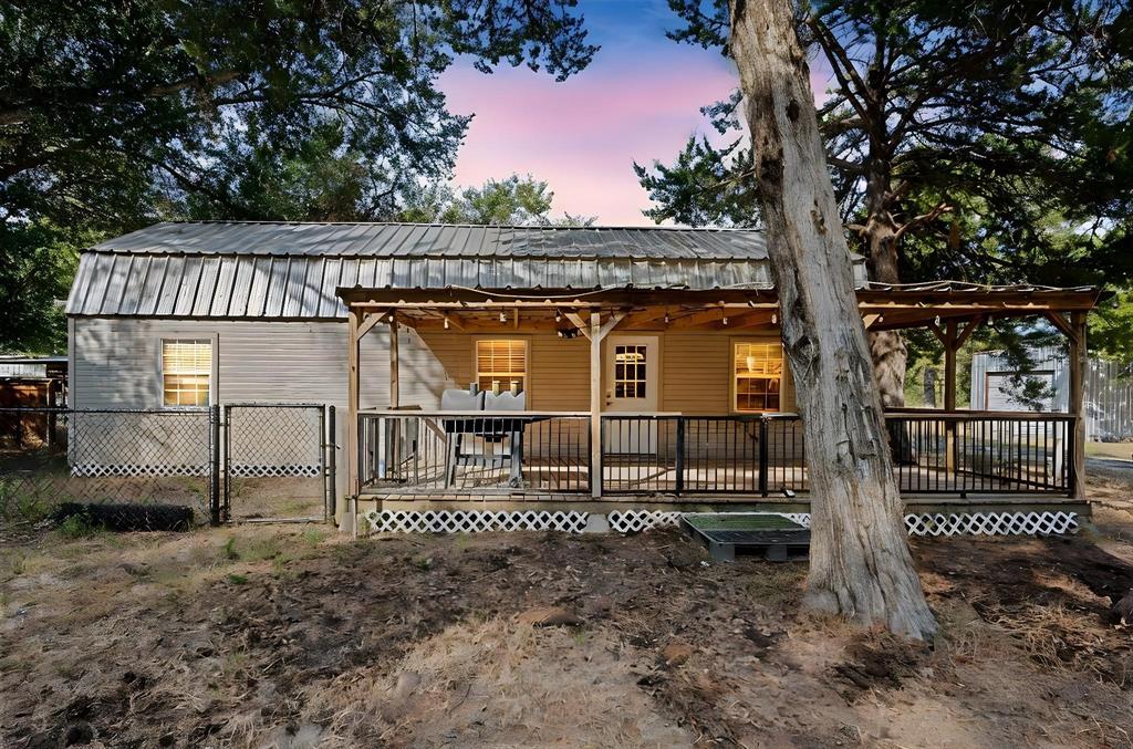 134 Maple Avenue Streetman, TX 75859 - Photo 1 of 19 Back of house with a wooden deck, a gate, and a metal roof