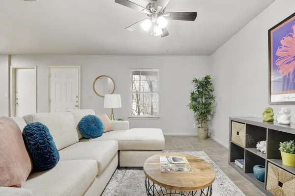 a living room with furniture and a potted plant