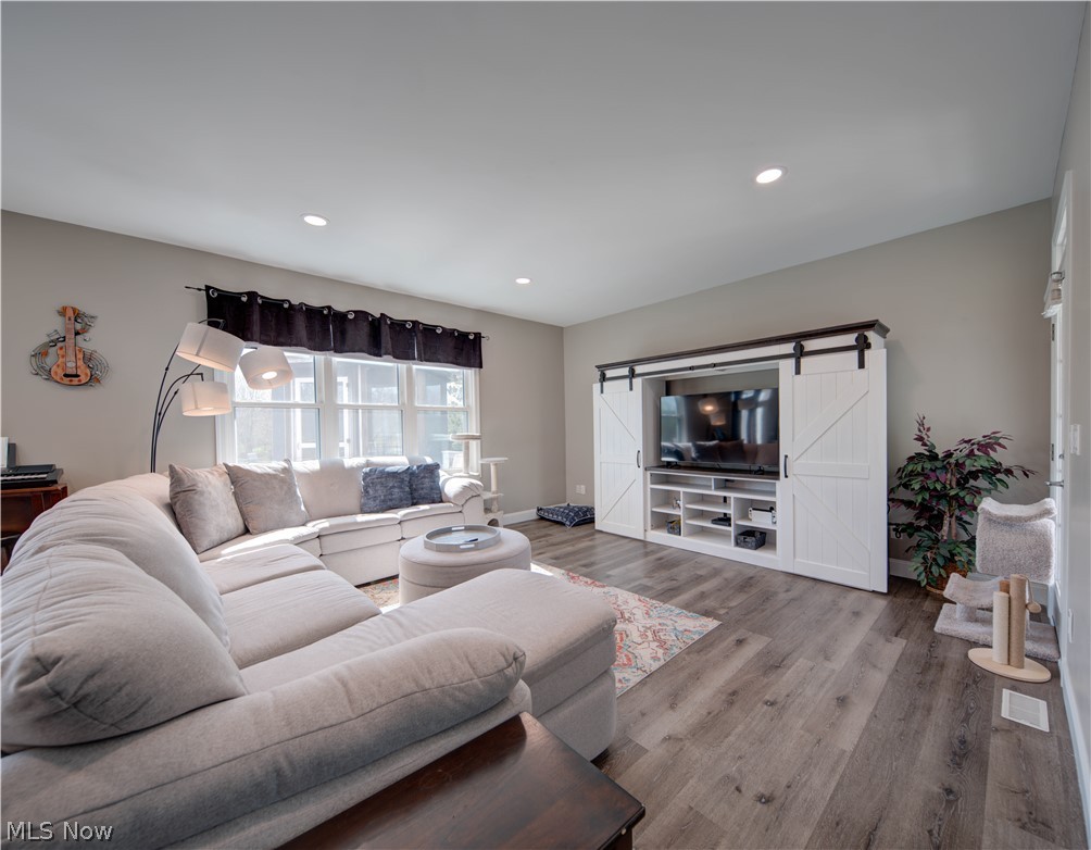 9900 Mentor Road Chardon, OH 44024 - Photo 13 of 49 Living room with hardwood / wood-style floors and a barn door