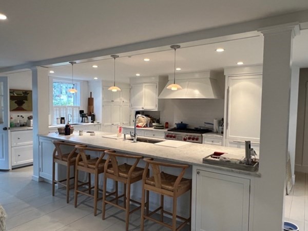 19 Morse Street Edgartown, MA 02539 - Photo 3 of 8 a kitchen with a sink and chairs