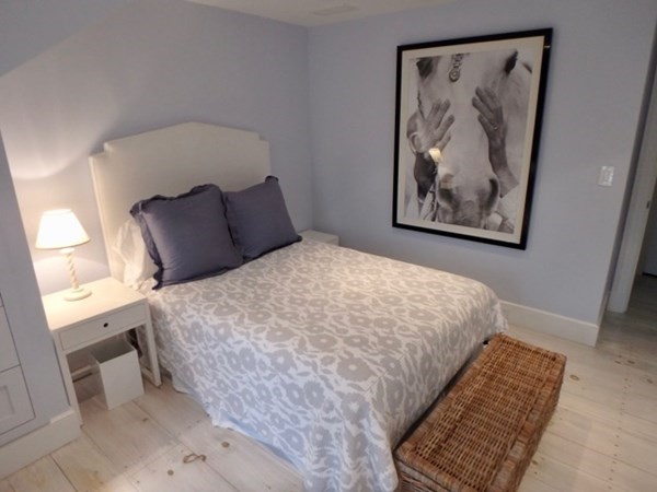 19 Morse Street Edgartown, MA 02539 - Photo 8 of 8 a large bed sitting in a bedroom next to a window