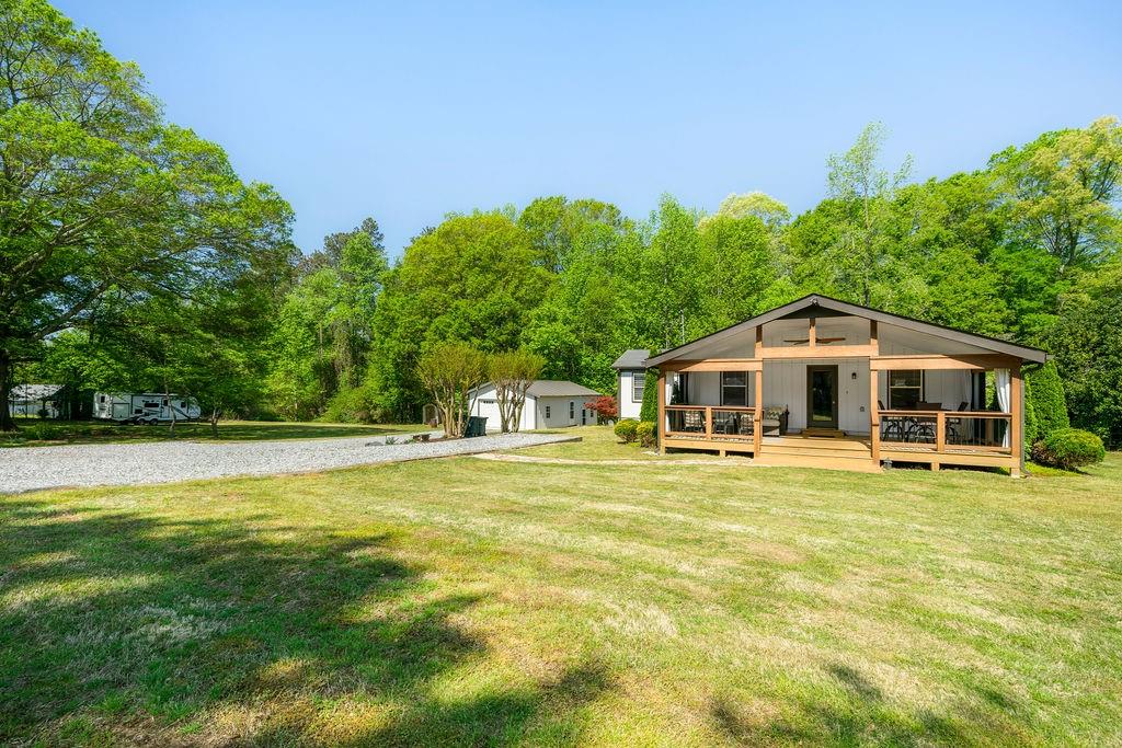 363 Lacy Road Canton, GA 30115 - Photo 1 of 1 a yellow house with swimming pool in front of it