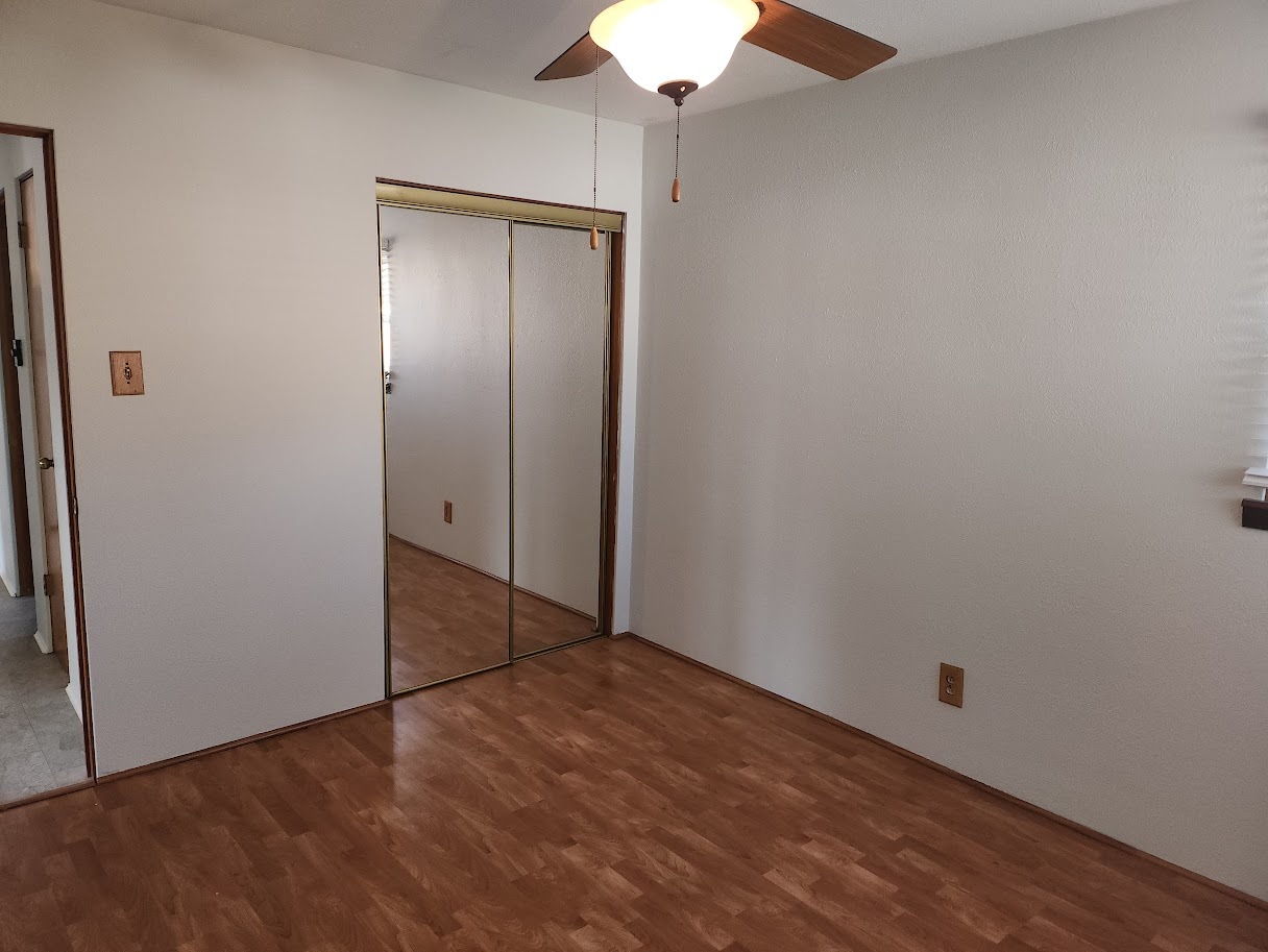 307 Cameron Avenue Lockport, IL 60441 - Photo 8 of 17 an empty room with wooden floor and fan