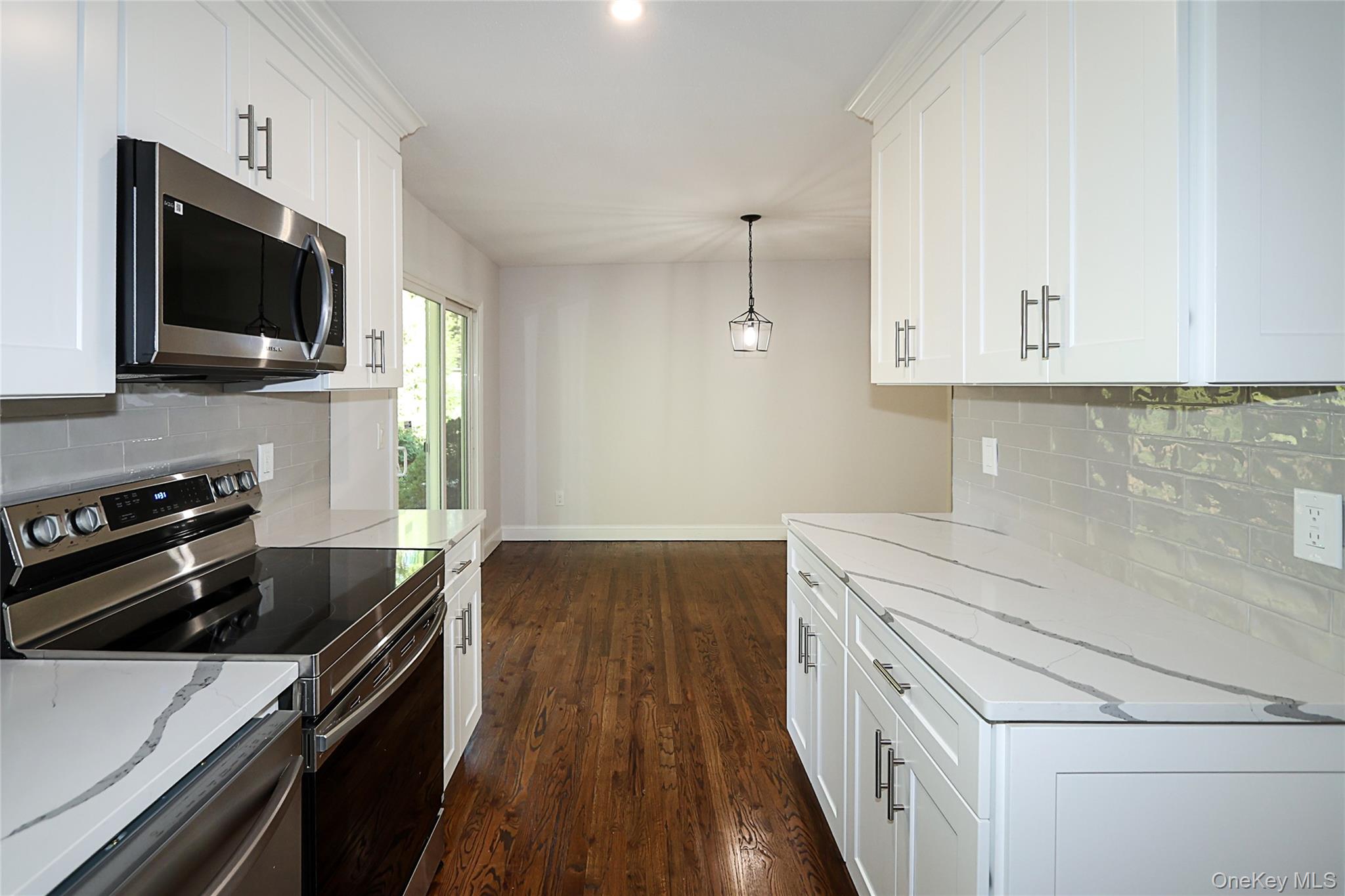 10 Smith Yaphank, NY 11980 - Photo 13 of 26 a kitchen with a stove and a microwave
