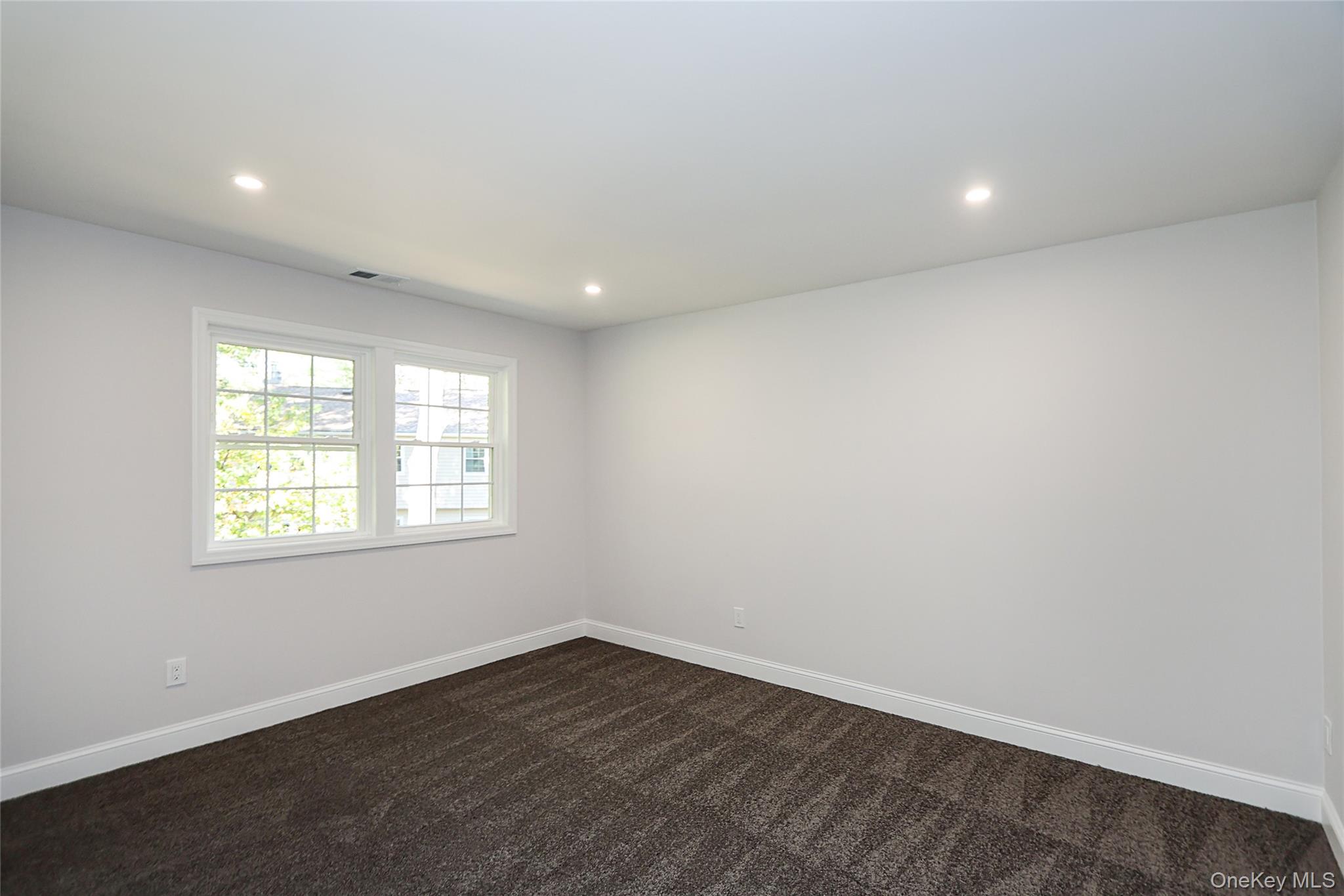 10 Smith Yaphank, NY 11980 - Photo 16 of 26 an empty room with wooden floor and windows