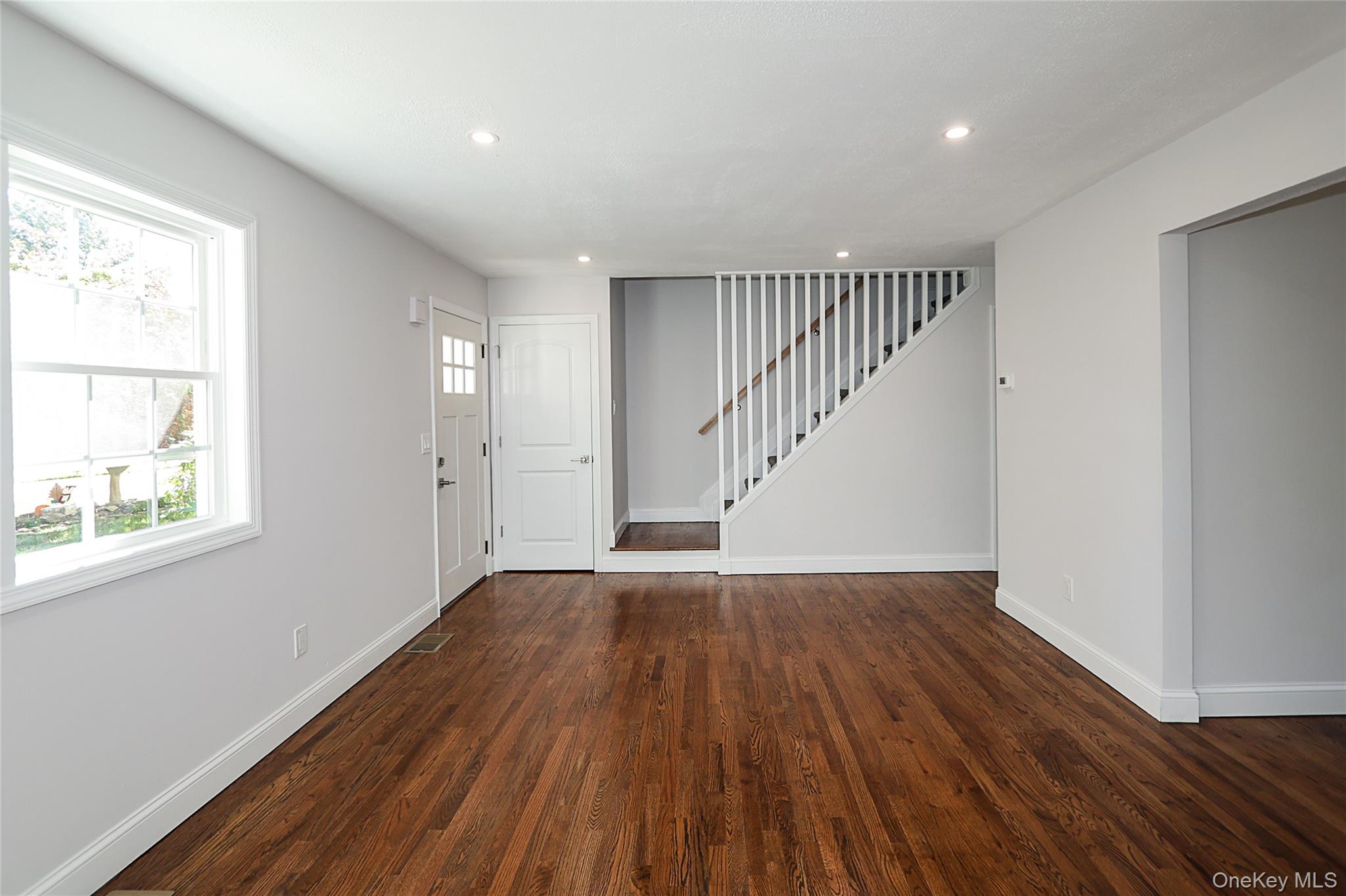 10 Smith Yaphank, NY 11980 - Photo 5 of 26 a view of an empty room with wooden floor and a window