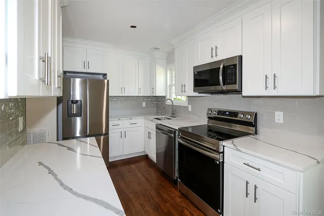 a kitchen with a sink stove and refrigerator