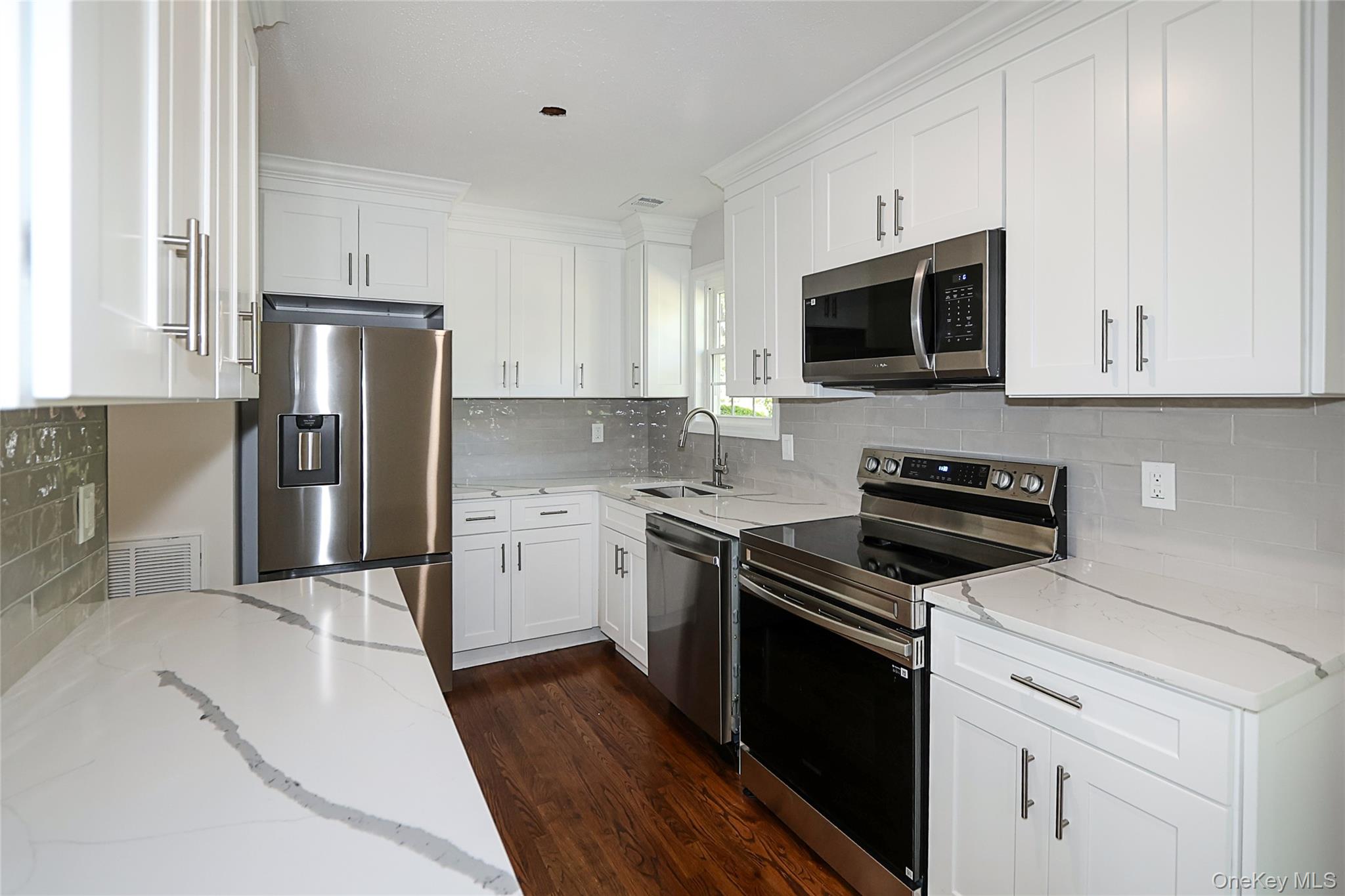 10 Smith Yaphank, NY 11980 - Photo 10 of 26 a kitchen with a sink stove and refrigerator