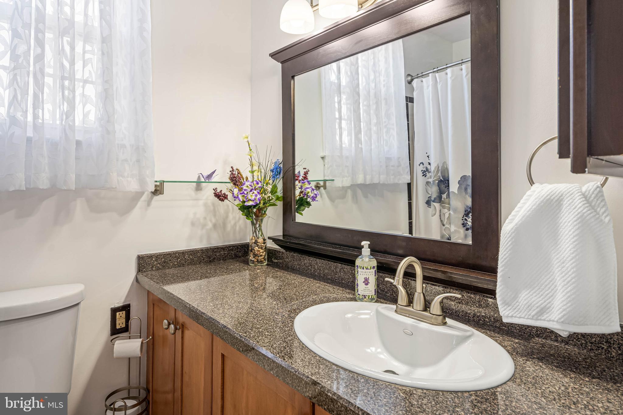 121 Decker Drive Newark, DE 19711 - Photo 23 of 57 a bathroom with a granite countertop sink and a mirror