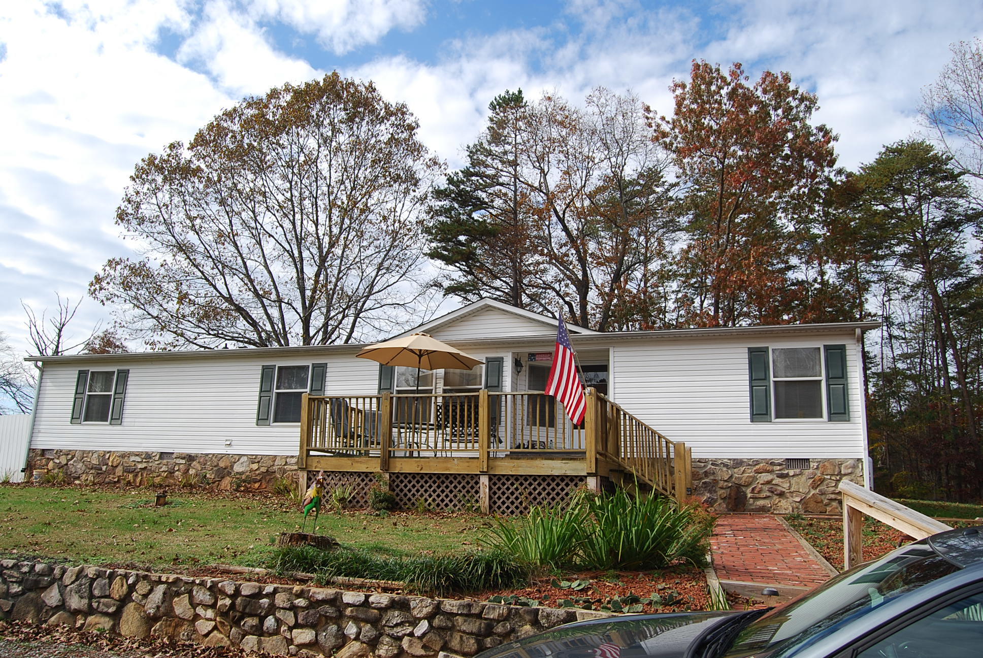 1019 Doe Mountain Road Goodview, VA 24095 - Photo 1 of 53 a front view of a house with a garden