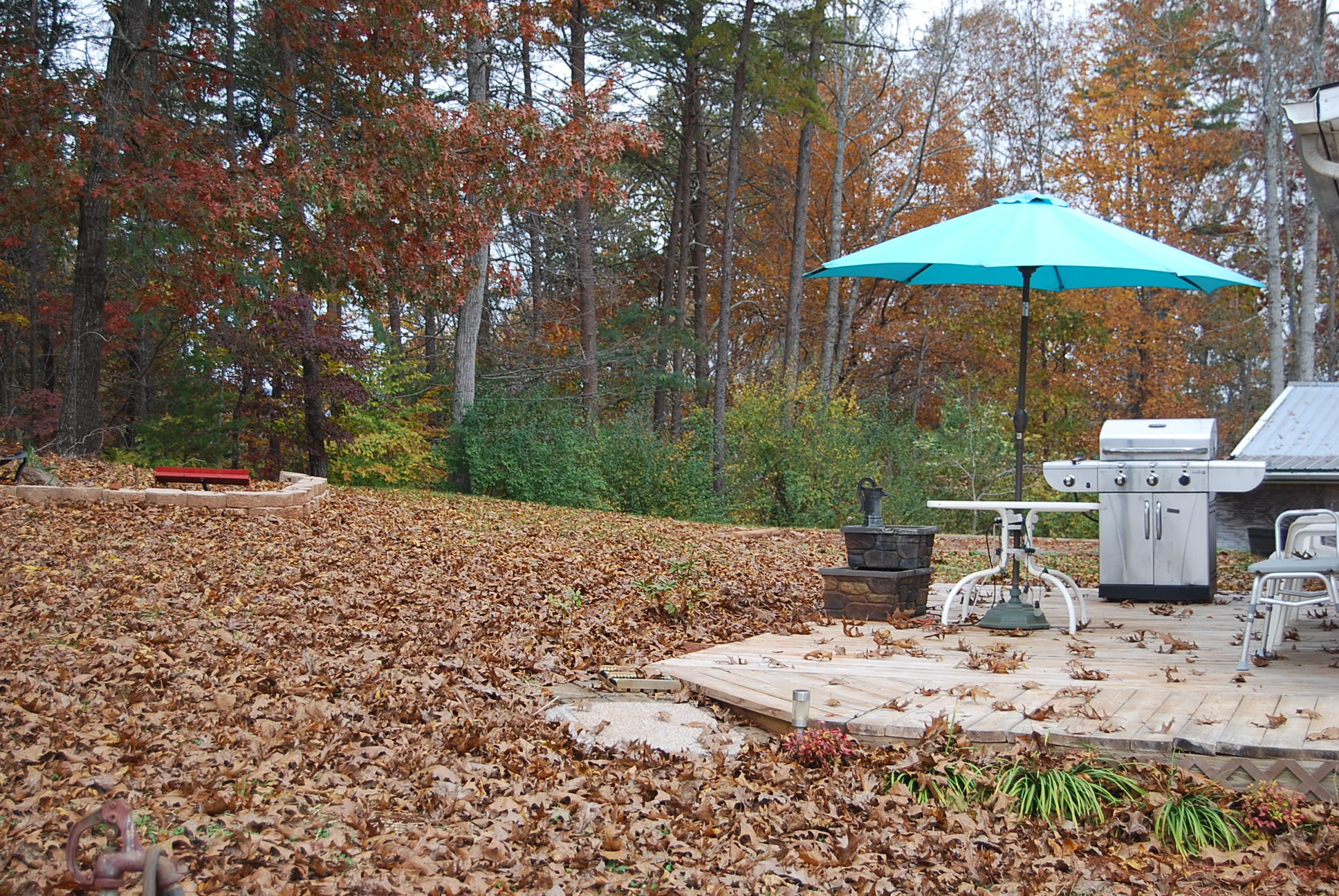 1019 Doe Mountain Road Goodview, VA 24095 - Photo 12 of 53 a view of a backyard with table and chairs under an umbrella