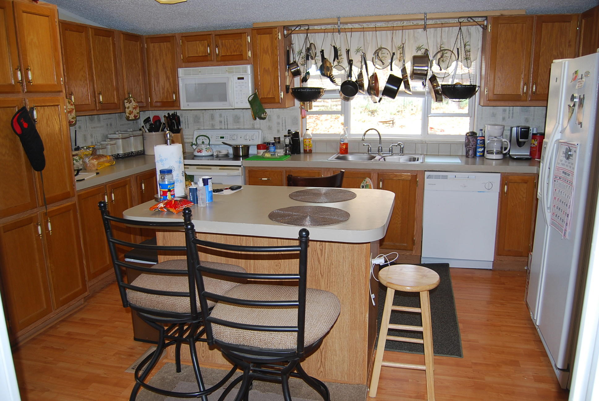1019 Doe Mountain Road Goodview, VA 24095 - Photo 45 of 53 a view of dining room and kitchen with furniture a rug and wooden floor