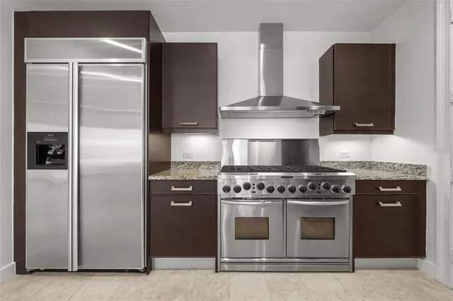 a stove top oven sitting inside of a kitchen