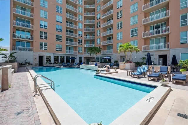 a swimming pool with outdoor seating and plants