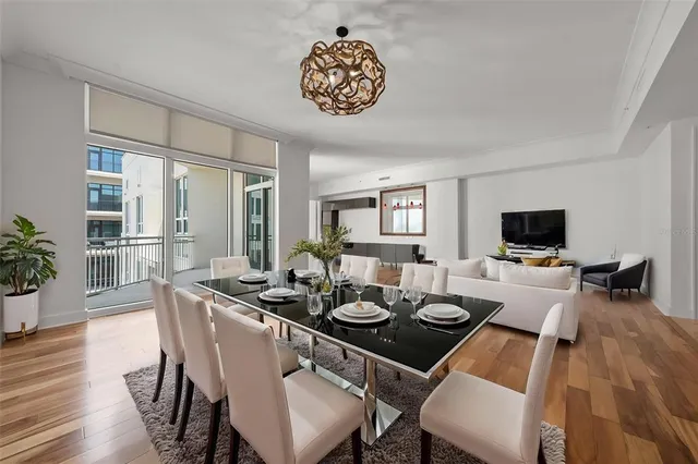 a dining room with furniture a window and wooden floor