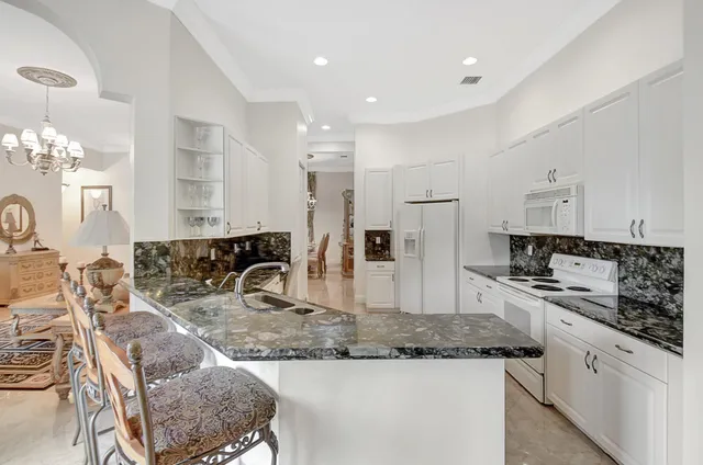 a kitchen with stainless steel appliances granite countertop a sink and cabinets