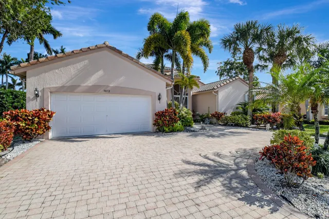 a front view of a house with a yard and a garage