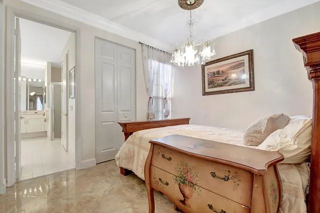 a bed room with a bed and a chandelier