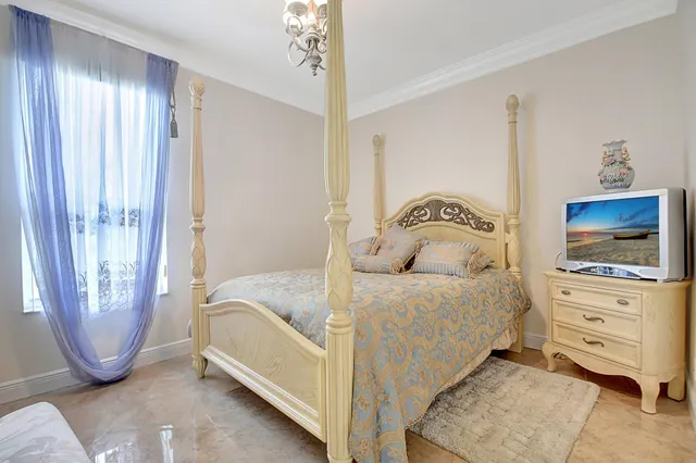 a bedroom with a bed and a chandelier